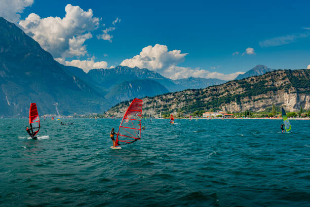 Torbole, Italy - September, 5. 2019: Some windsurfer in front of Torbole in Italy. Torbole is located at Lake Garda and very famous for surfing.