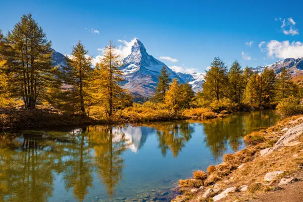 Photo of Great autumn panorama with famous peak Matterhorn reflected in Grinjisee lake. Swiss Alps, Valais, Switzerland