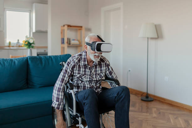 istock Disabled Senior Man in Wheelchair using Virtual Reality Eyeglasses 1183365055