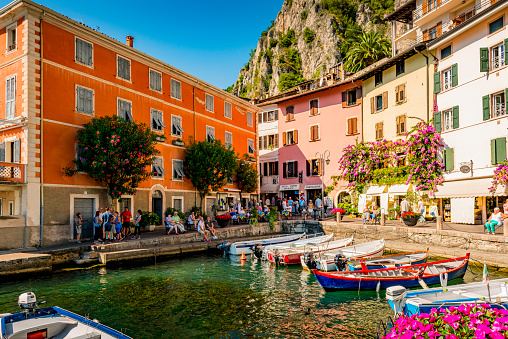 Limone, Italy - September, 5. 2019: Tourists at the harbor of Limone. Limone is located at Lake Garda and a very touristic village.