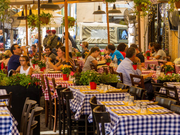 Rome, Italy - Sep 16, 2015: Tourists and local residents enjoying the night life, dining in outdoor street restaurants in the center of Rome, Italy.