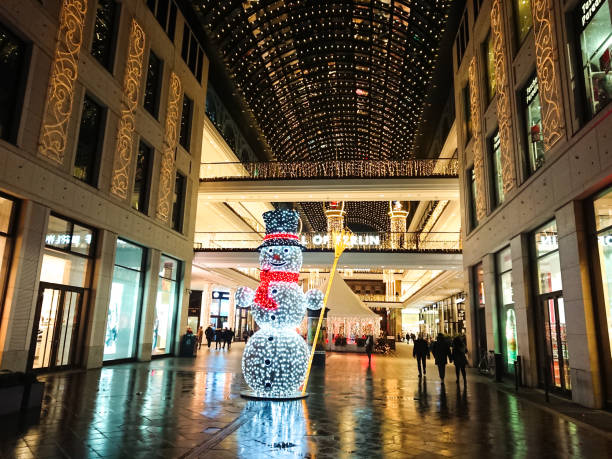 Rotterdam, The Netherlands, December 4, 2023: view along Koopgoot lower level shopping street with Christmas decorations during the blue hour on a rainy day