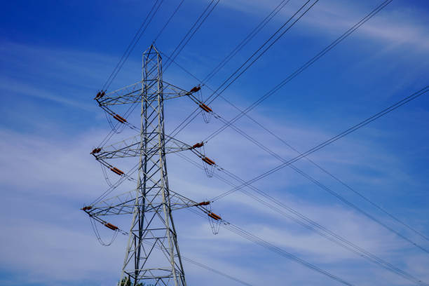 istock Electrical power pylons with a blue sky background 1183367589