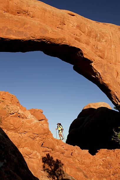 istock Young Man Hiking Up Steep Rocks In Moab, Utah 118336836