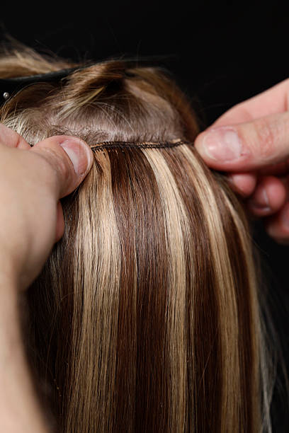 istock Hairstylist Applying Hair Extensions 118337164