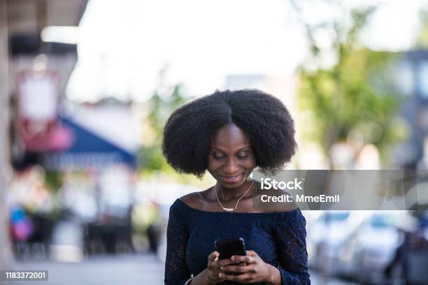 Africanamerican Woman Using Smartphone Onthego Stock Photo - Download Image Now - 30-39 Years, Adult, Adults Only