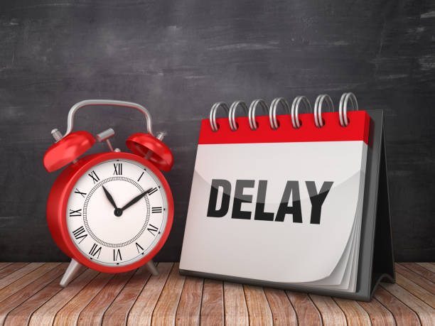 istock DELAY Calendar with Alarm Clock on Chalkboard Background - 3D Rendering 1183372080