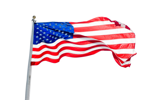 The national flag of the United States of America waving in the wind on a clear day. Patriotism concept. 3D illustration
