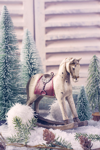 Vintage rocking horse and small christmas trees