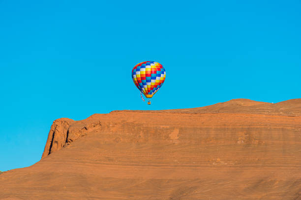 A single hot air balloon flying in Red Rock State Park near Gallup, New Mexico.