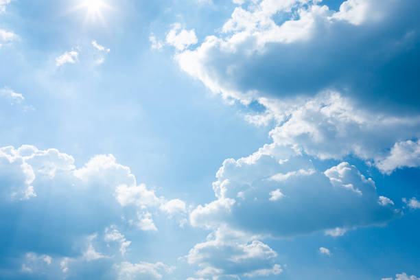 istock blue sky and bright clouds with the sun shining 1183376897