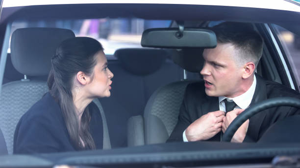istock Husband and wife quarreling in auto, misunderstanding in relations, breakup risk 1183378886