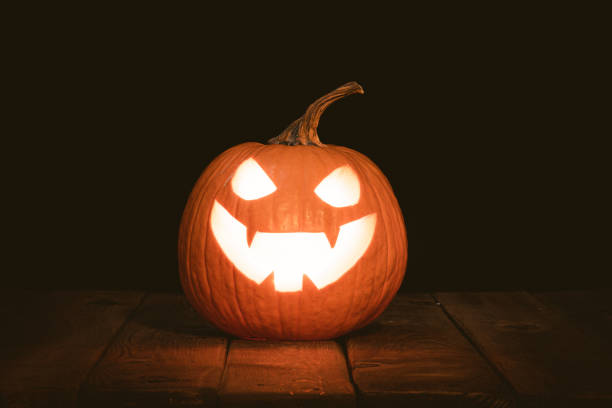 istock Halloween pumpkin head jack lantern with burning candles 1183379844