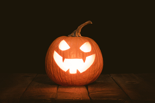 Halloween pumpkin head jack lantern with burning candles