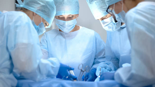 surgical operating team performing thoracic surgery in modern hospital, health - cirurgia imagens e fotografias de stock