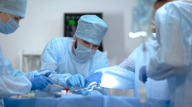 Surgeon team working in operation room, performing cardiothoracic surgery stock photo