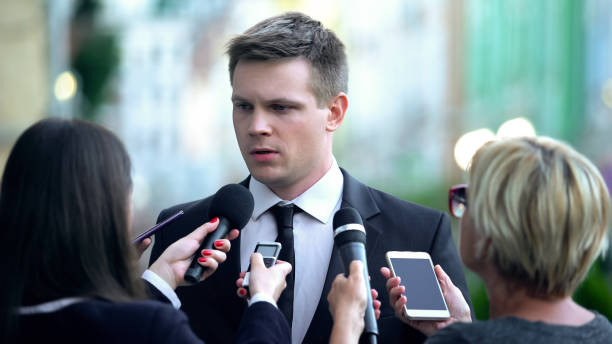 istock Unsatisfied politician giving interview to newspaper journalists, problem 1183381953