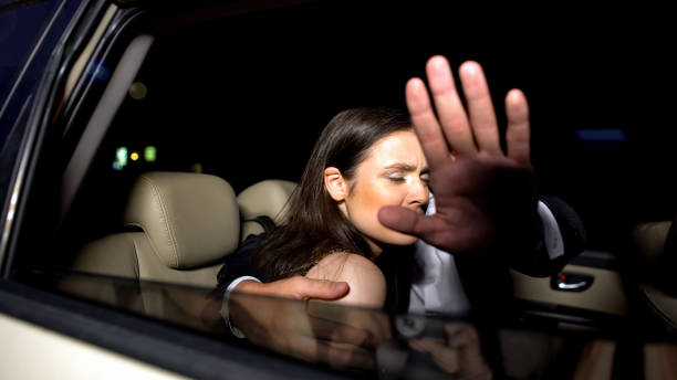 celebrity couple in car hiding with hand from magazine photographers cameras - relationship difficulties flash imagens e fotografias de stock