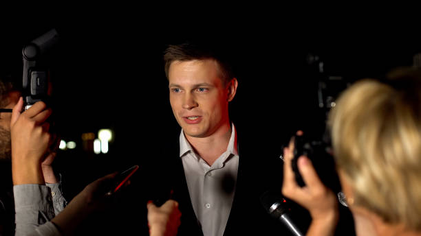 istock Handsome actor giving interview on press conference before movie premier, fame 1183382007