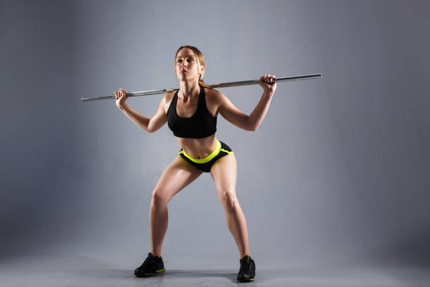 istock strong athletic woman fitness instructor doing squats 1183382045
