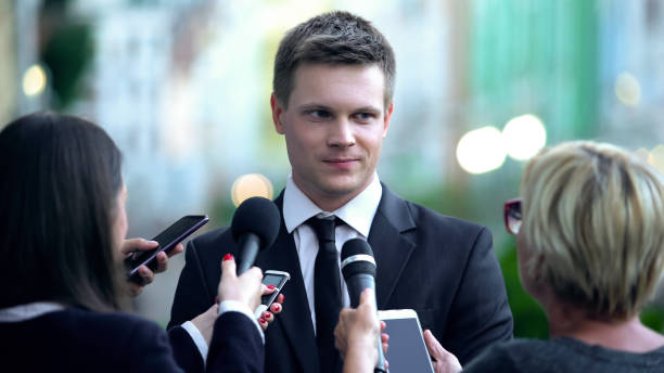 istock Smiling male millionaire giving interview on press conference, public relations 1183382096
