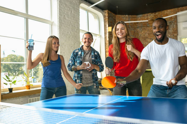 istock Young people playing table tennis in workplace, having fun 1183383702