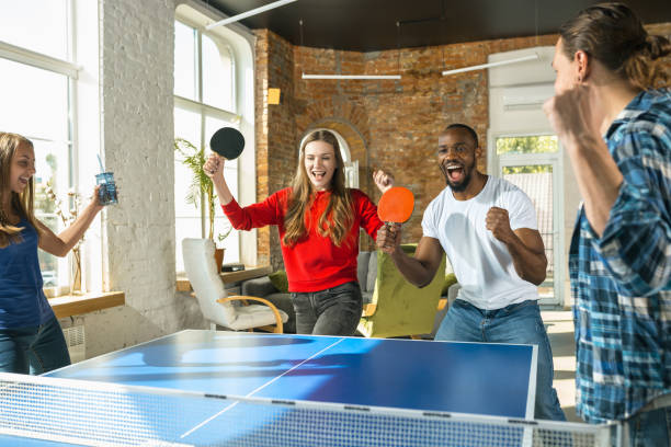 istock Young people playing table tennis in workplace, having fun 1183383711