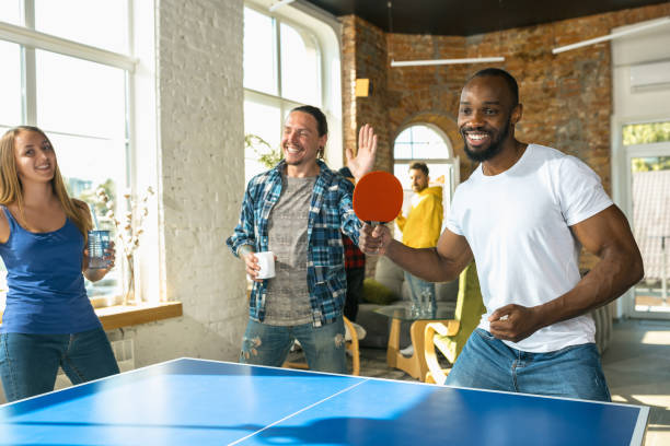 istock Young people playing table tennis in workplace, having fun 1183383716