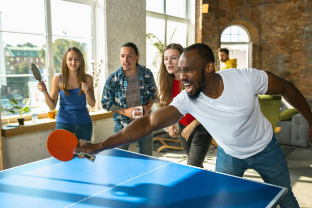 istock Young people playing table tennis in workplace, having fun 1183383724