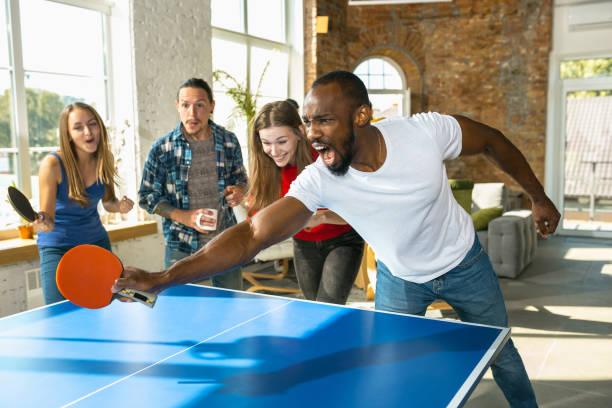 istock Young people playing table tennis in workplace, having fun 1183383727
