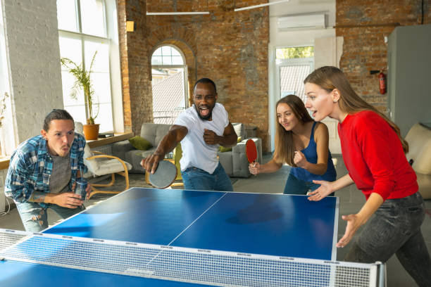 istock Young people playing table tennis in workplace, having fun 1183383758