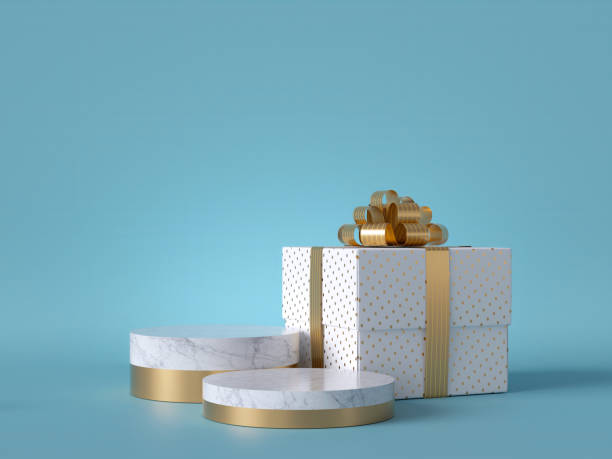 istock 3d wrapped Christmas gift isolated on blue background. White square box with golden bow. Round marble podium, blank pedestal steps, empty space. Cylinder platform. Product showcase mockup. 1183384335