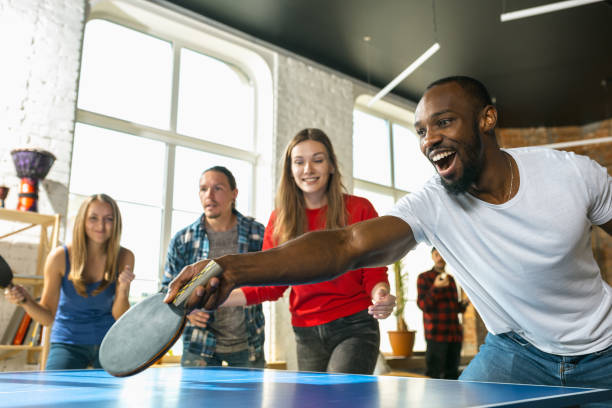 istock Young people playing table tennis in workplace, having fun 1183384399