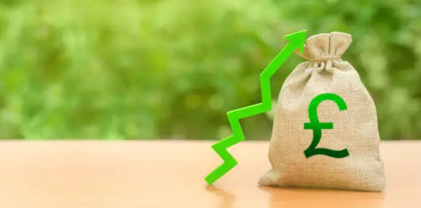 Photo of Money bag with pound sterling symbol and green up arrow. The growth of the national economy and the strength of the exchange rate. Brexit Great Britain. Investment attraction. loans subsidies