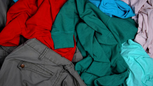 istock Used clothes lying at market, second hand for recycling, help for people in need 1183387315