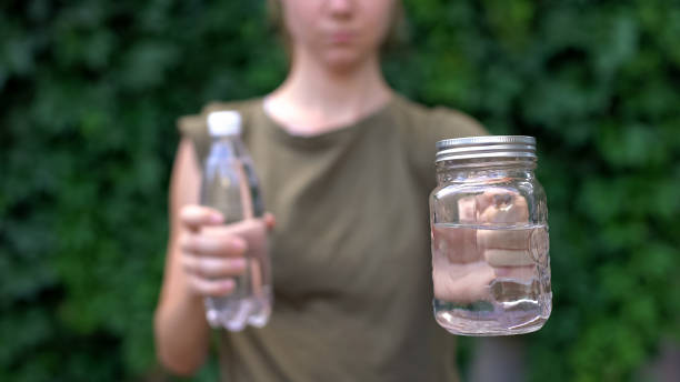 istock Lady showing glass mug to camera, preferring it to plastic bottle, saving earth 1183387439