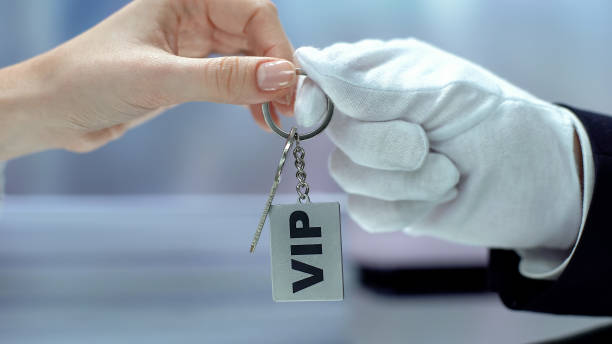 istock VIP written on keychain customer taking from hand in glove, luxurious vacations 1183389070