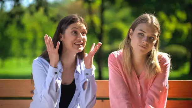 Photo of Young woman feeling tired of talking friend, communication problem, relations