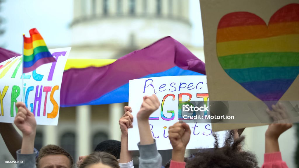 Crowd raising posters chanting to respect LGBT rights, support for gay marriage LGBTQIA Rights Stock Photo