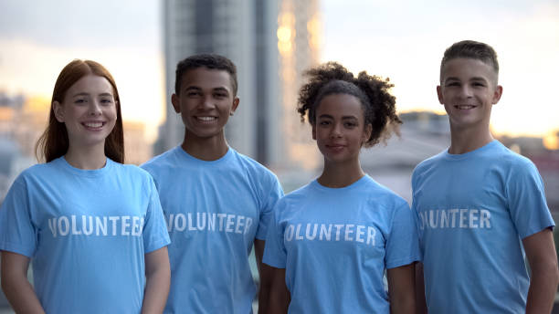istock Smiling teens volunteers sincerely smiling on camera, international help project 1183391988