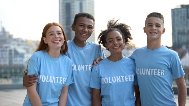 istock Happy young people volunteer t-shirts posing camera, social teamwork, help 1183392794
