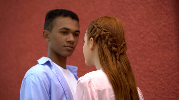 Teenagers Couple Looking At Each Other Beautiful Hairstyle Of Red Haired  Girl Stock Photo - Download Image Now - iStock