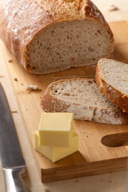 istock Bread and butter on wooden kitchen board. 1183398595