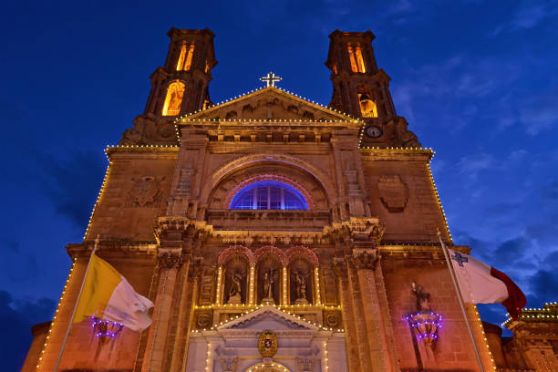 istock Church facade with fairy light against blue sky 1183400992
