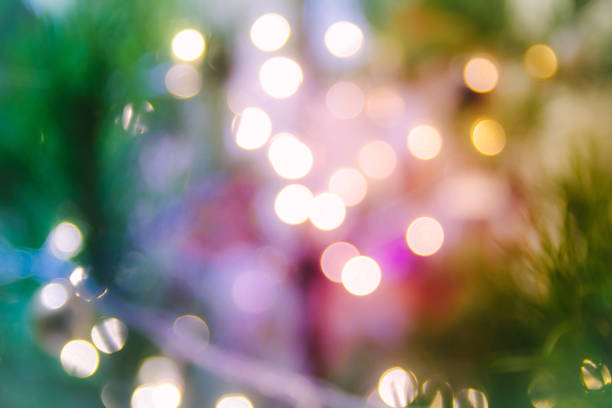 istock Christmas and new year background with sparkle light and spruce.  Blurred bright background with tree and garland. Happy holiday. 1183401684