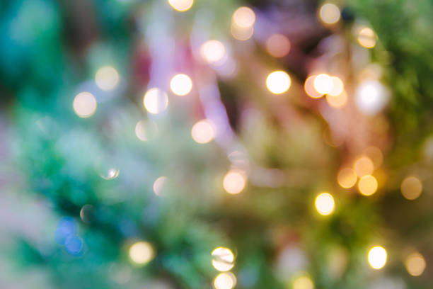 istock Christmas and new year background with sparkle light and spruce.  Blurred bright background with tree and garland. Happy holiday. 1183401702