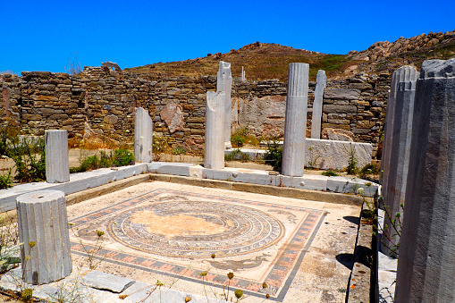 view of the house of dolphins in the archaeological city of Delos Island, near Mykonos, beautiful Cycladic island, in the heart of the Aegean Sea.