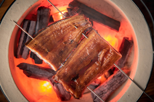 unagi, cooking traditional japanese eel with charcoal