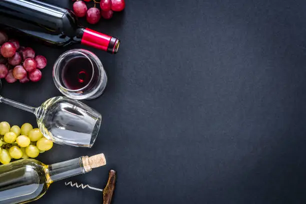 Photo of Wines background: red, rosé and white wines on black background with copy space