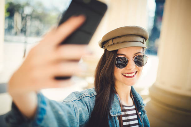 istock Woman taking a selfie by her phone 1183407024
